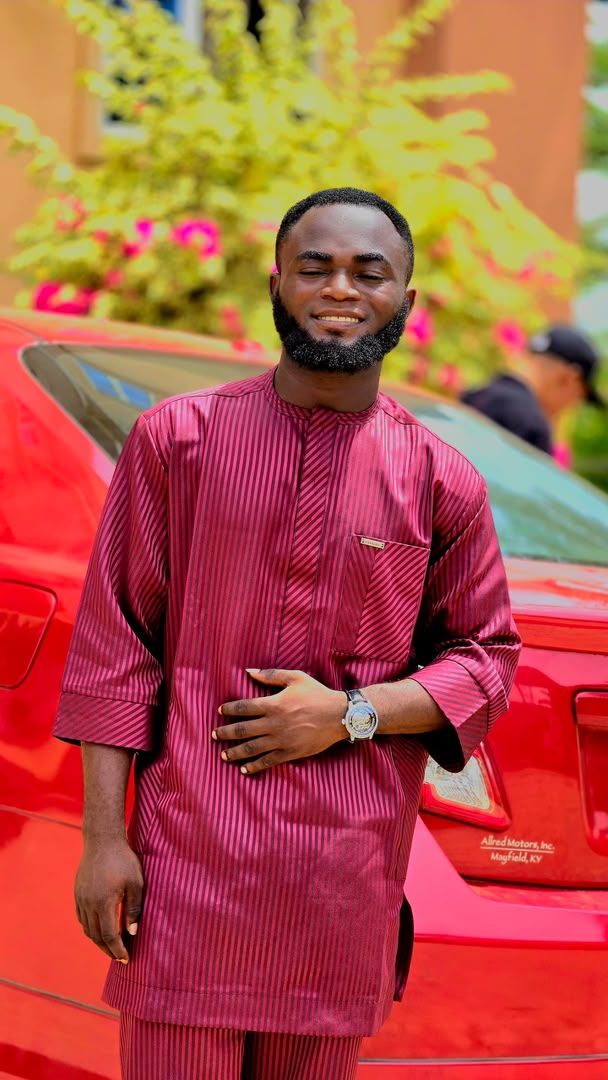 Portrait of Taiwo Emma O in a burgundy outfit