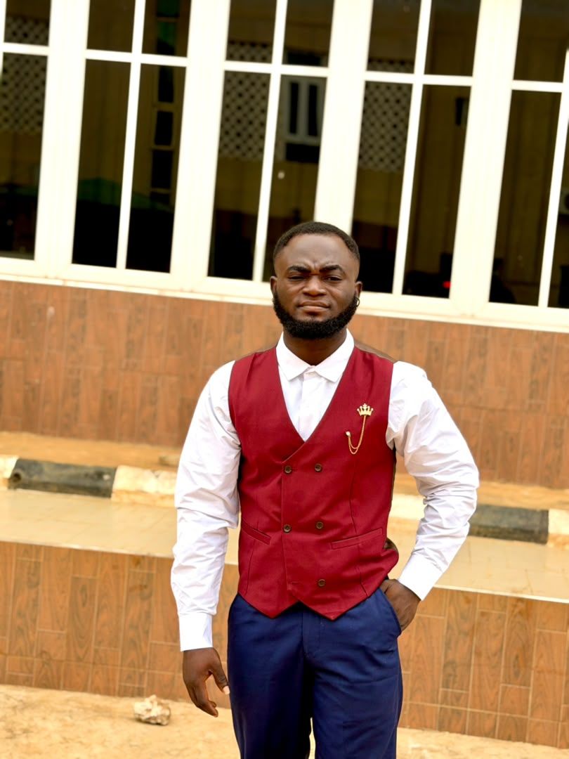 Taiwo Emma O in a red waistcoat